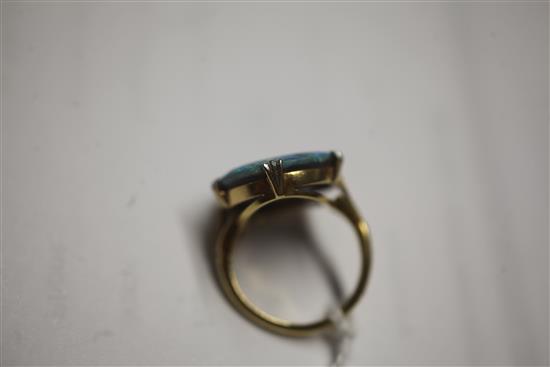 An 18ct gold and platinum set oval black opal dress ring, size L.